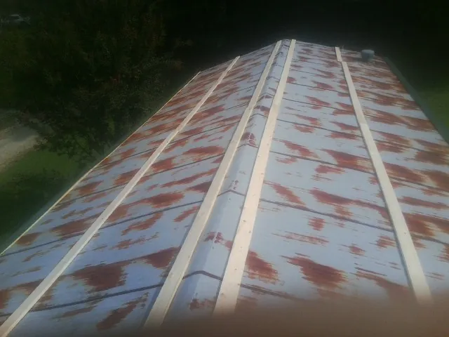 Rusted metal roof panels with new wood purlins before replacement — Storm Damage Roof Repair in Guyton by Roofing Brothers